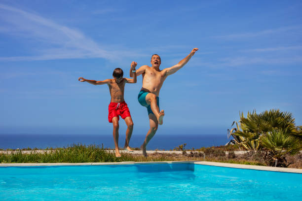 istock Father and son enjoy pool time fun together during summer trip 1993473979
