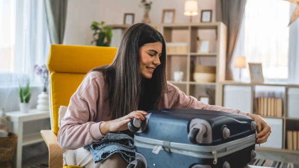 istock One woman pack suitcase baggage prepare for vacation holiday 1993528877