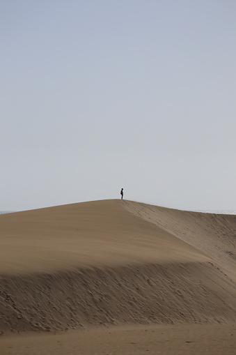 Man standing on top of the desert