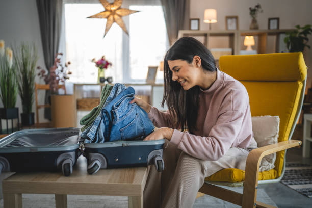 istock One woman pack suitcase baggage prepare for vacation holiday 1993543078