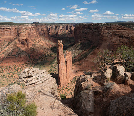 Canyon de Chelly National Monument in Arizona features spectacular formations of sandstone, which visitors may view from overlooks on the rim of the canyon.  The monument sits on land wholly owned by the Navajo Nation.  The park is operated by the National Park Service in cooperation with the Navajo, and members of the tribe live in the bottom of the canyon amid flowing streams and cottonwood trees.