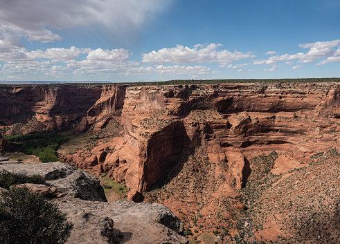 Canyon de Chelly National Monument in Arizona features spectacular formations of sandstone, which visitors may view from overlooks on the rim of the canyon.  The monument sits on land wholly owned by the Navajo Nation.  The park is operated by the National Park Service in cooperation with the Navajo, and members of the tribe live in the bottom of the canyon amid flowing streams and cottonwood trees.