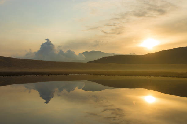 A tranquil evening with the sun setting by the river.