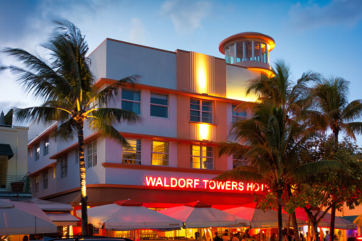 Illuminate art deco style hotel on Ocean Drive in the Art Deco District of South Beach Florida USA at twilight.
