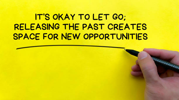 istock Hand writing It is okay to let go affirmation on yellow cover background. Affirmation concept. 1993599596