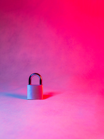Vertical photo depicting a closed padlock against red and blue backdrop, symbolizing closed options
