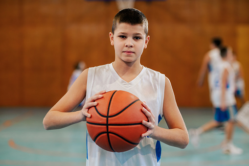 Basketball ball on Court Floor close up with blurred background.