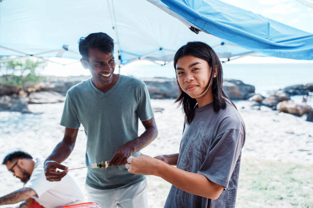 istock Friends grilling at the beach 1993739691