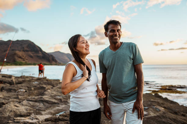 Affectionate multiracial couple enjoying sunset at the beach