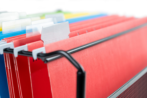 Closeup view of the colorful hanging file folder on the file organizer isolated over a white background