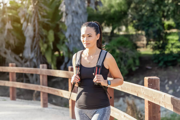 istock Woman hiking with backpack in park 1993753333