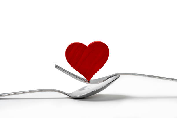 istock Silverware of fork and spoon with a red heart 1993759600