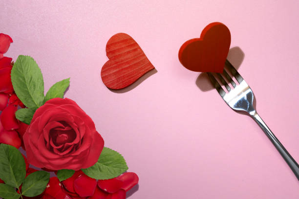 istock Silverware of fork with a red heart and rose flowerhead 1993760122
