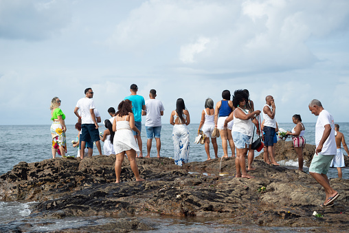 Salvador, Bahia, Brazil - February 02, 2024: Crowds of people who follow candomble are seen paying homage to iemanja on Rio Vermelho beach, in the city of Salvador, Bahia.