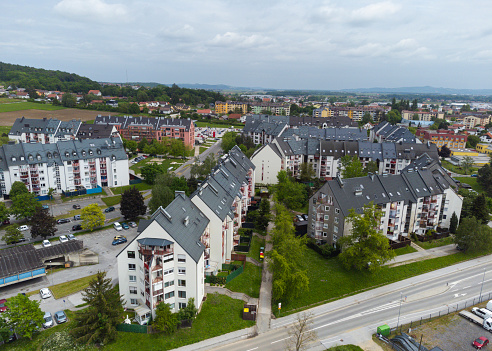 Aerial view of a suburban neighborhood with rows of houses and green spaces on an overcast day. Location: Ptuj, Slovenia
