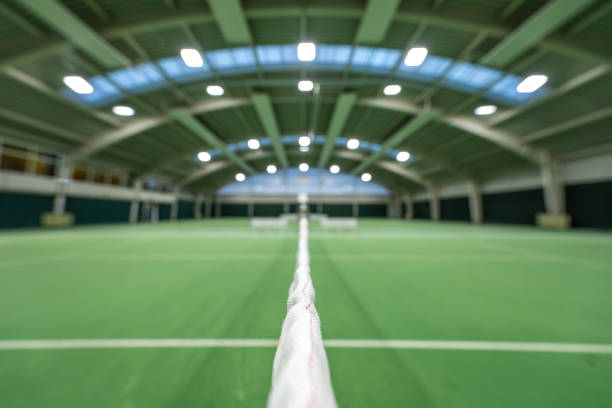 Empty green tennis courts under roof selective focus