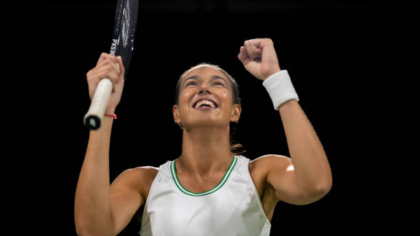 Female tennis player showing winner gesture