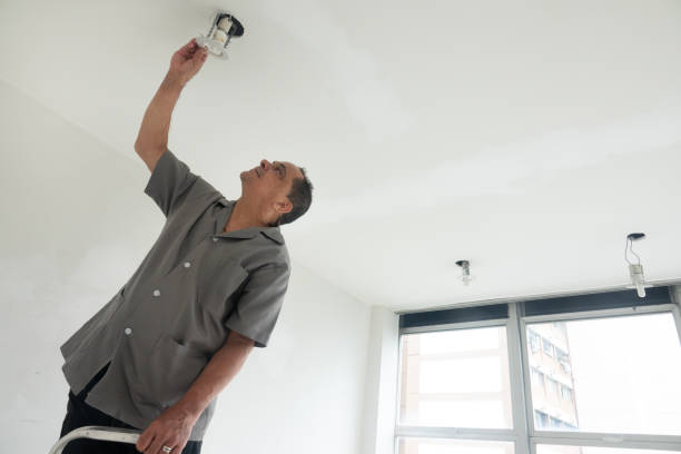 istock Electrician fixing ceiling lamp wiring 1993803304