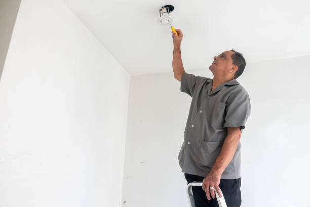 istock Electrician fixing ceiling lamp wiring 1993803809
