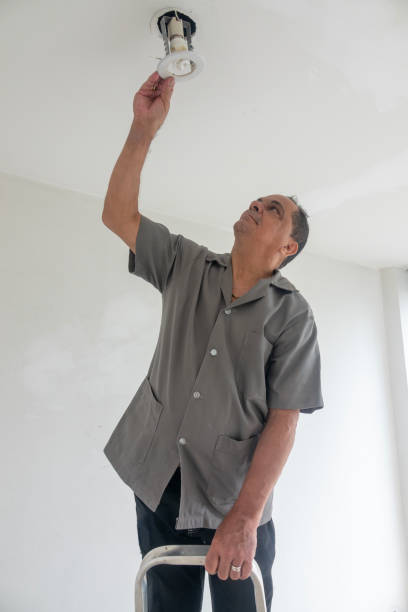 istock Electrician fixing ceiling lamp wiring 1993803811
