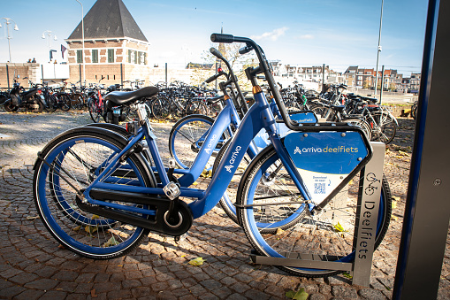 Picture of a bicycle from Arriva Deelfiets, on a station in Maastricht, Netherlands. The Arriva deelfiets service offers a convenient and environmentally friendly way to travel around the city, especially for the last mile of your journey. These bicycles can be rented through the Glimble app, which allows users to unlock a bike, pause their ride, and complete their rental at specific parking locations. With a network of locations in cities like Maastricht, this service provides an accessible mode of transportation for both residents and visitors