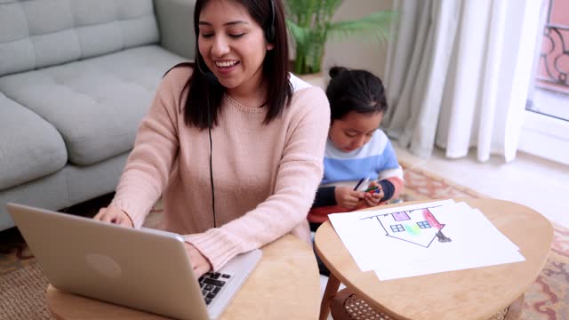 Asian mother and child having enjoy together while working at home. Family love concept