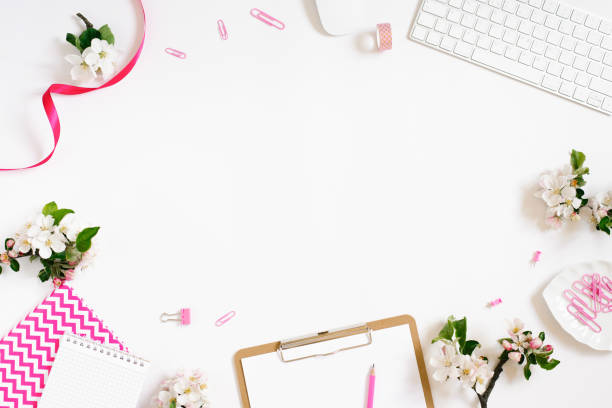 istock Flat lay home office workspace female blogger background with white modern keyboard, notebook and apple flowers, copy space on white background 1993865824