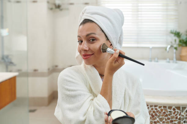 istock Happy young woman applying powder 1993872464