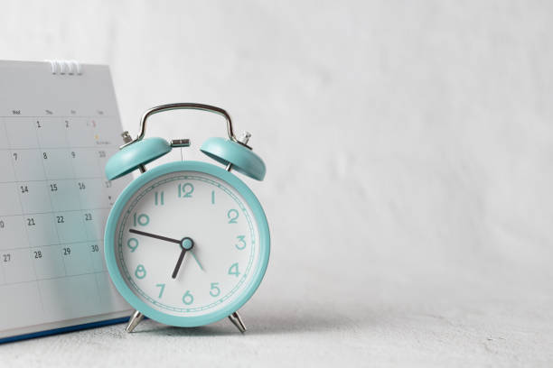 istock The alarm clock and calendar positioned on a white background symbolize dates, time, planning, and appointments. 1993876359