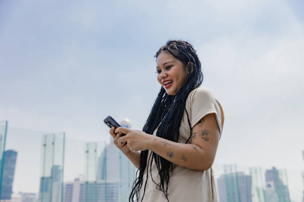 istock Young woman using digital device outdoor. asian. 1993884916