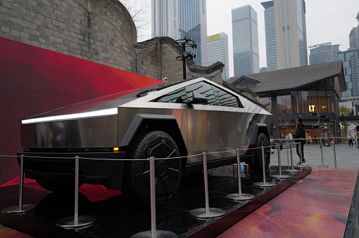 ChengDu China - February 5 2024: The Tesla Cybertruck exhibition at Taikoo Li Business Center in Chengdu attracts a crowd of onlookers, set against the backdrop of traditional Chinese architecture and modern office buildings, showcasing the beauty of the collision between tradition and modernity.Captured with the Leica Q3.Chengdu,China.