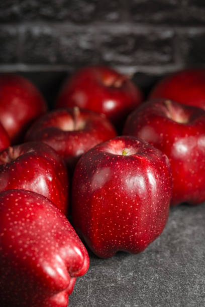 istock red apples on wooden background 1993954115
