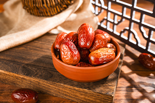 Dates in basket on wooden table