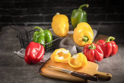 Fresh yellow, red and green bell peppers on fabric, Organic vegetables
