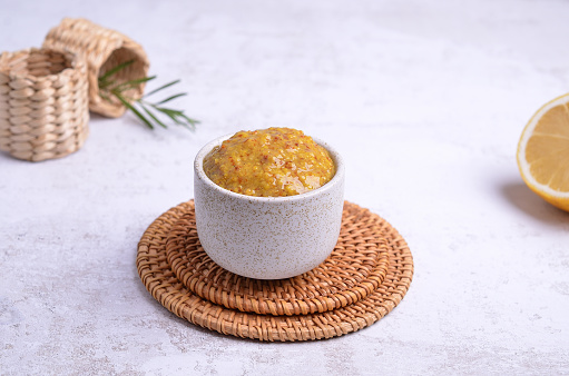 Traditional Bavarian mustard in a ceramic dish on a light background. Selective focus.