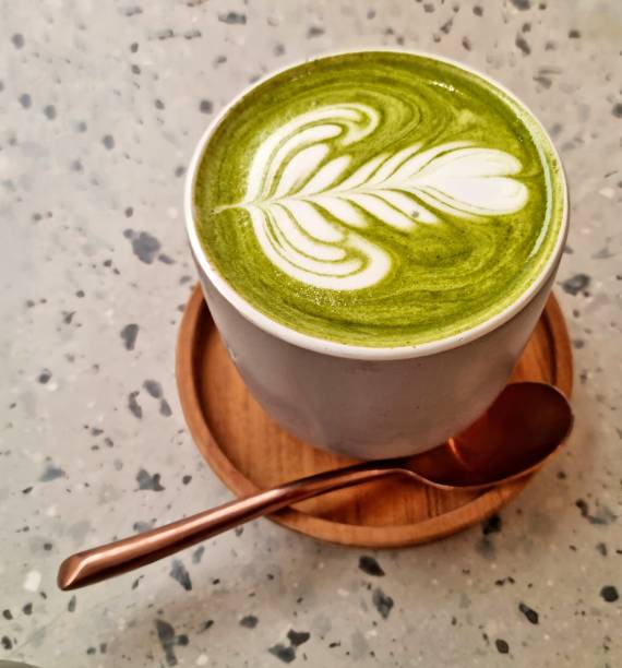 Matcha green tea with Latte art in a grey cup