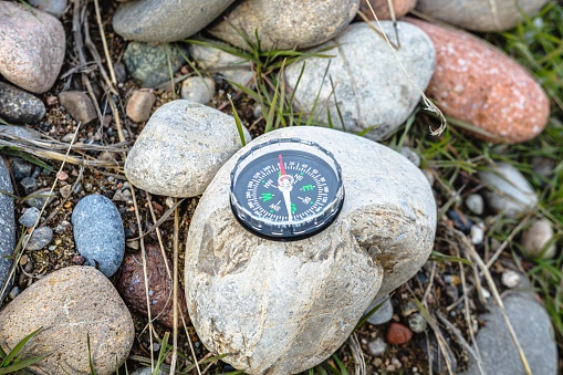 A close up of the needle of an old compass