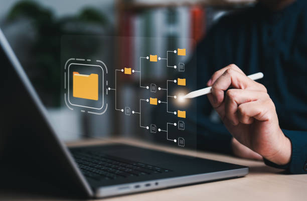 istock DMS, document management system concept. Businessman using laptop connecting to digital cloud file folder, data transfer backup, digital transformation, file sharing, searching, and managing files. 1994047147