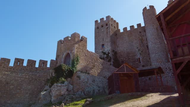 Medieval strong castle tower and side building with fortified walls from Óbidos, Portugal.