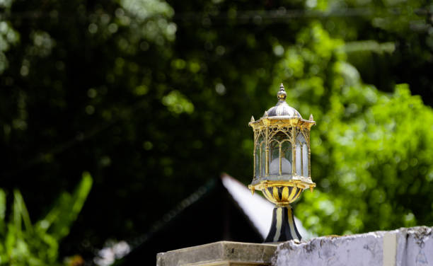 a golden garden lamp on the wall