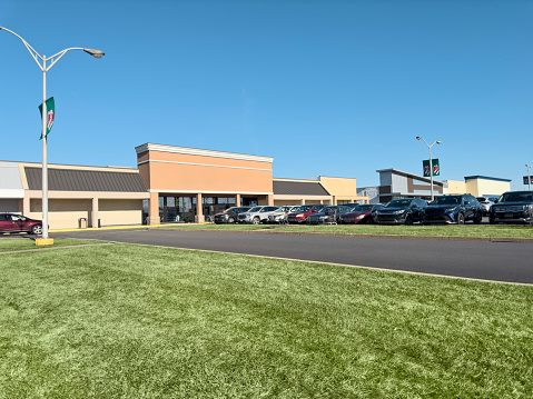 Exterior shot of a mall and parking lot in daytime
