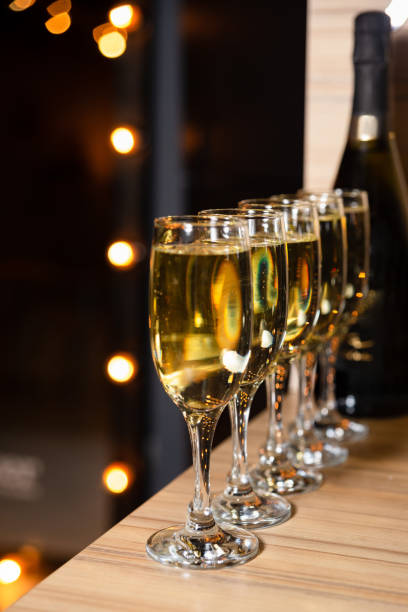 istock Champagne Glasses Lined Up With Bokeh Lights 1994210570