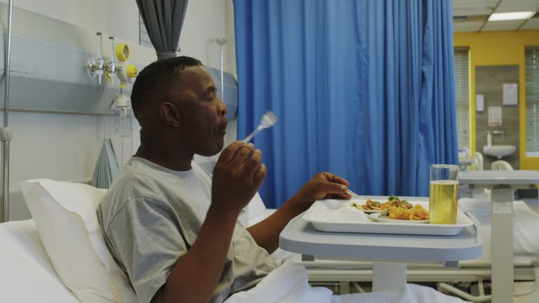 Side view senior man eating in hospital bed