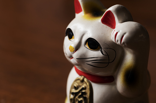 Bronze statuette of fun cat isolated over white