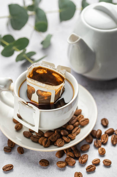 istock Drip coffee bag with ground coffee in  cup 1994230809