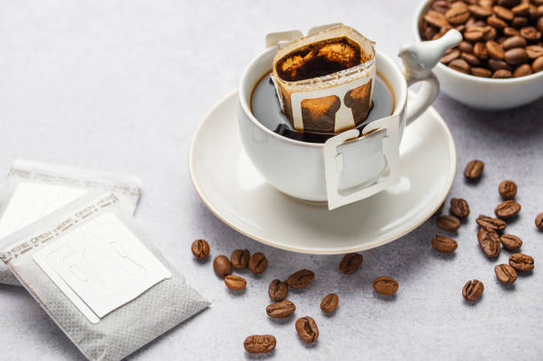 istock Drip coffee bag with ground coffee in  cup 1994230811
