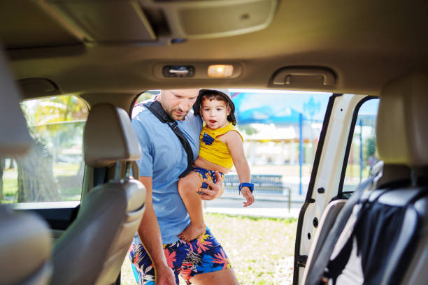 istock Father puts toddler boy into car 1994273840