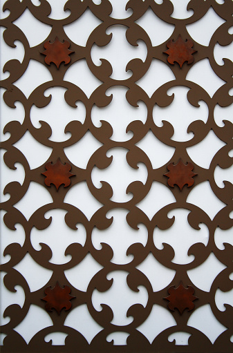 A perforated pattern metal plate on a wall