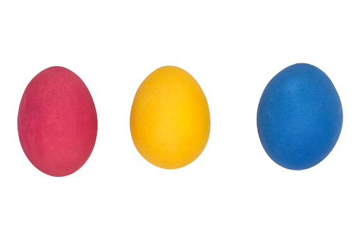 Easter eggs of three colors on a white background. Blue, red, yellow eggs for easter.