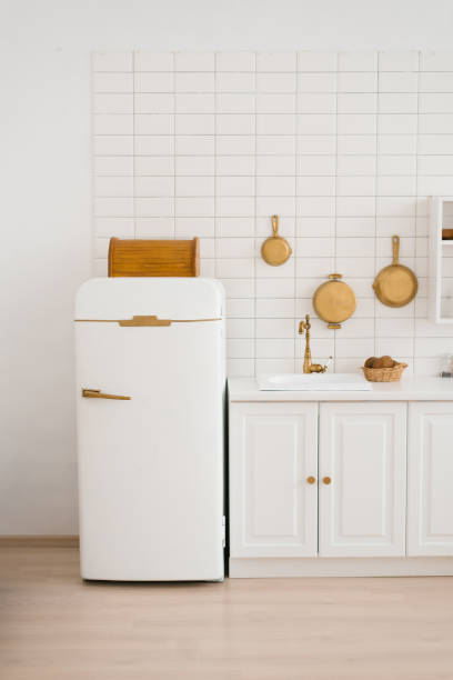 istock Modern new light wooden kitchen interior with white furniture and kitchen utensils 1994347897